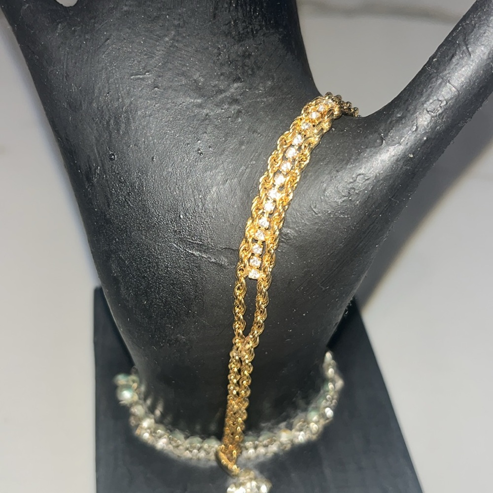 Gorgeous gold tone bracelet with studs braided or twisted design.